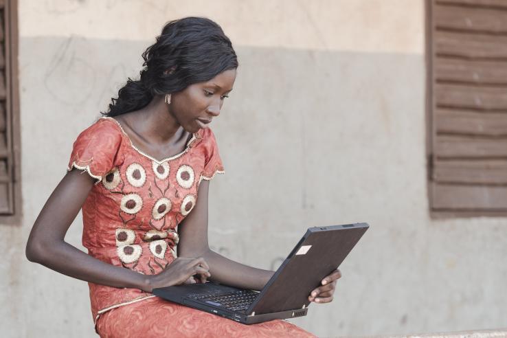 Woman sitting with computer on her lap