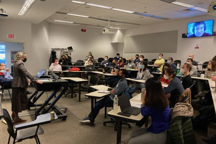 classroom of students sitting in desks facing the professor