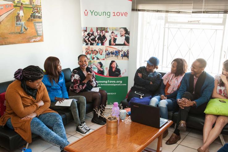 Group of people sitting on two couches 