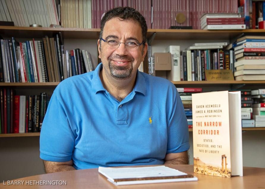 Daron Acemoglu holding his book, The Narrow Corridor